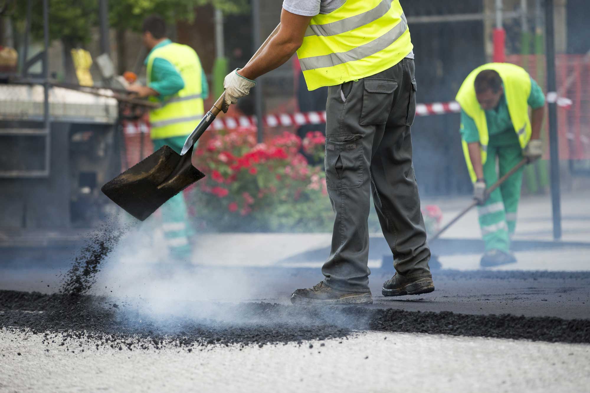Workers resurfacing a road